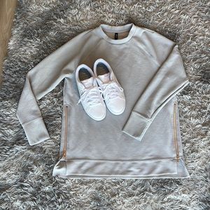 Light blue sweater shirt with zippers on the side